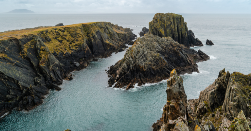 sharp rocky island cliffs with the sea surrounding below