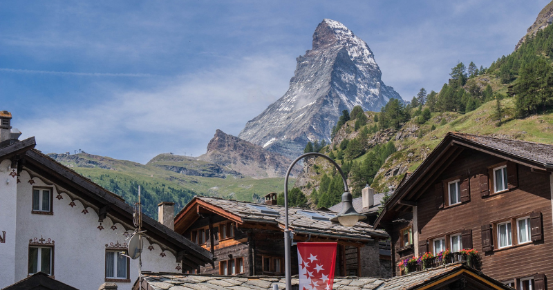 the Matterhorn mountain with chalet rooftops below