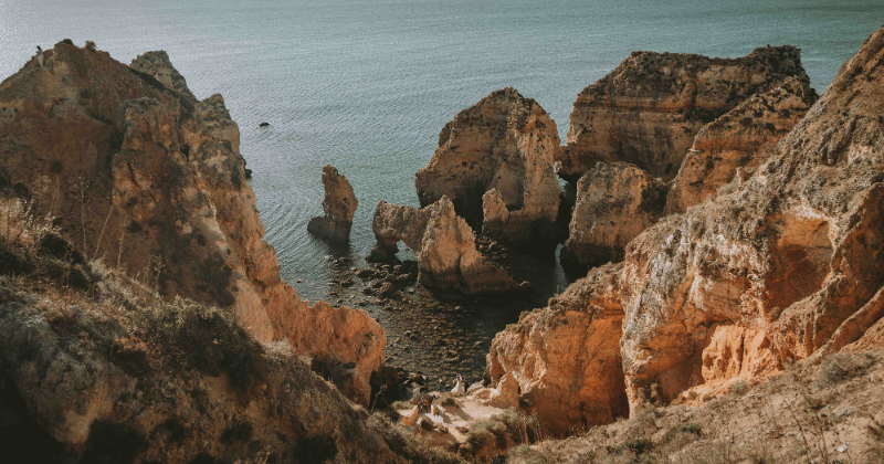 Rocky coastal formations rising from calm waters, showcasing stunning natural beauty and rugged landscapes along the UK coastline.