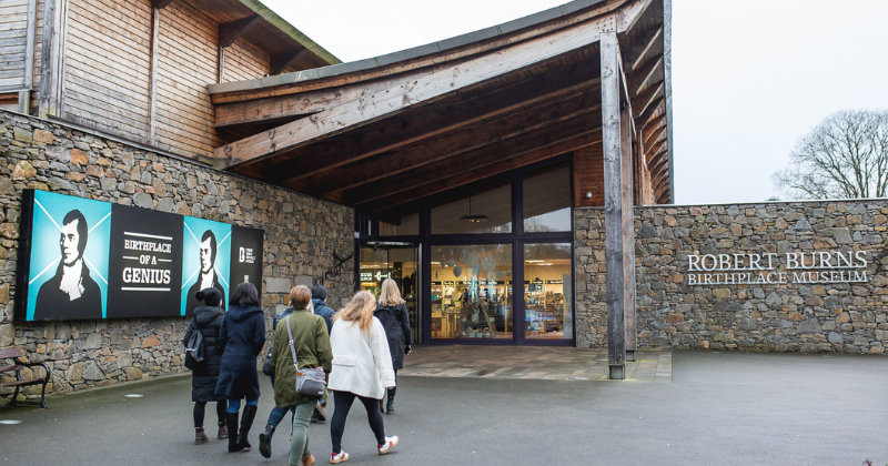 People walking into a building called the Robert Burns Birthplace Museum