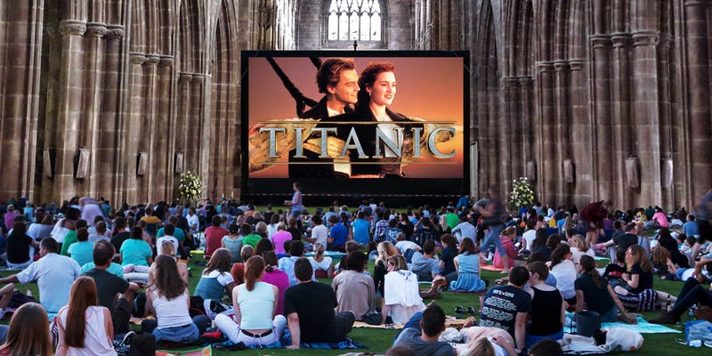 a crowd watching a movie inside a cathedral