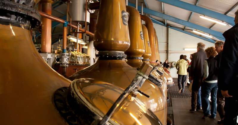 people walking by whisky stills