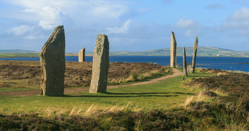 standing stones in a field by the ocean