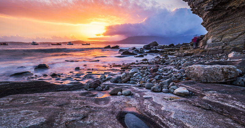 A rocky beach at sunset