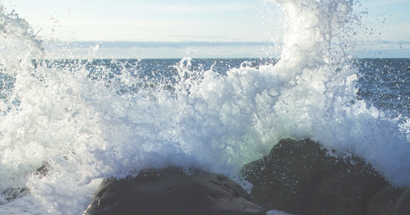 A wave splashing on rocks