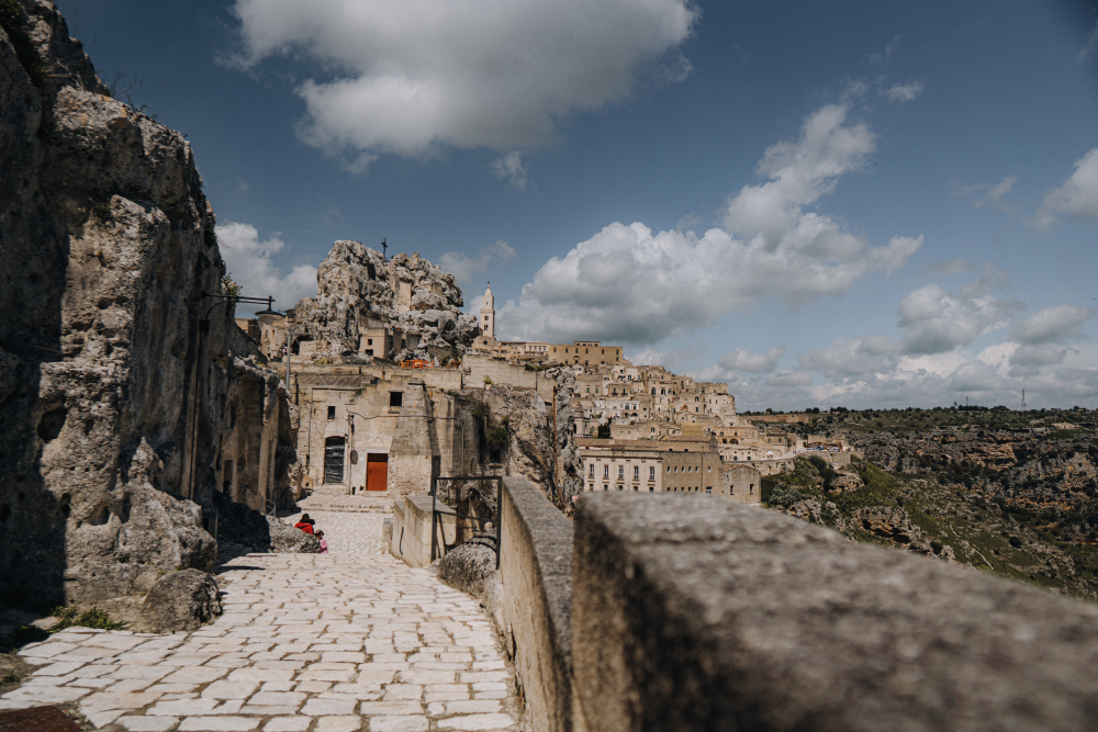 cobbled walkway leading up to the rocky landscape of matera