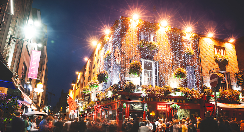 outside of Dublin's iconic temple bar with lots of lights for christmas