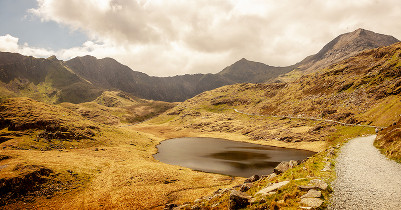 snowdonia moody mountain landscape with a small lake in the middle