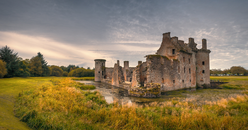 a ruined castle in a field