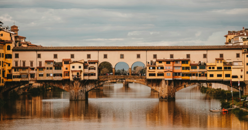 three arched bridge with covered building on top