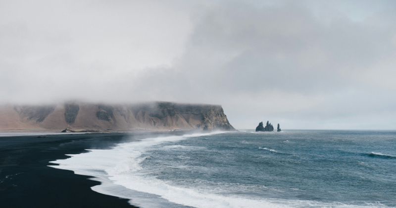coastal landscape of the sea bay with a cliff in the background