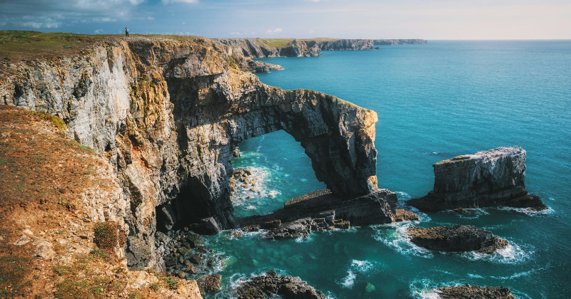 rocky cliffs with the blue sea below