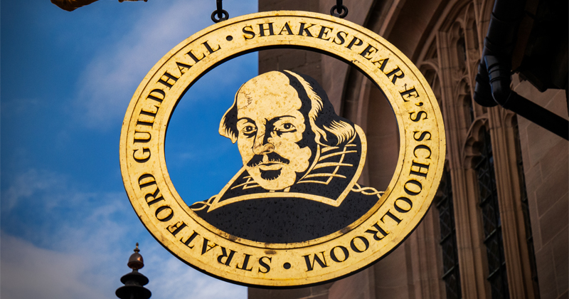 shakespeare's school logo with shakespeare's face in the middle