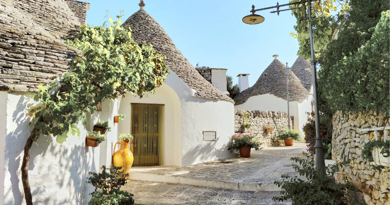 white stone huts with pointed stone roofs in Italy