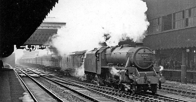 a black and white photo of a steam train