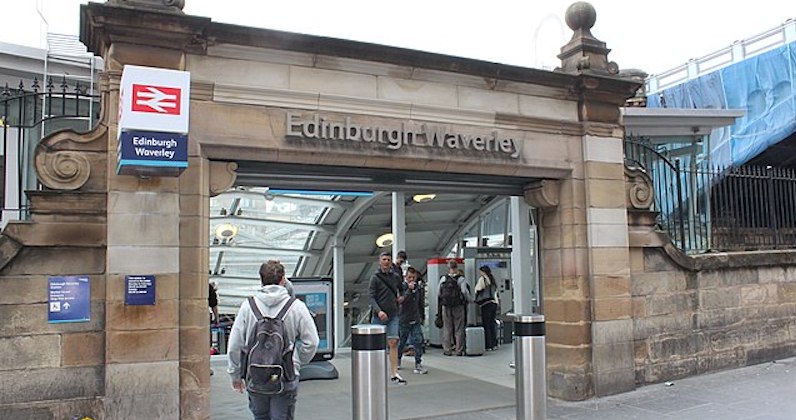 a man entering a station called Edinburgh Waverley