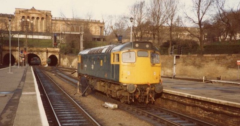 an old photo of a train sitting on the tracks