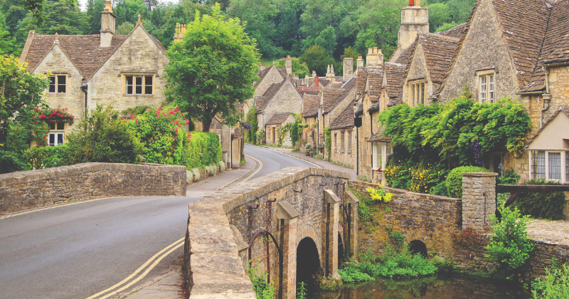 stone houses and a stone bridge over a river