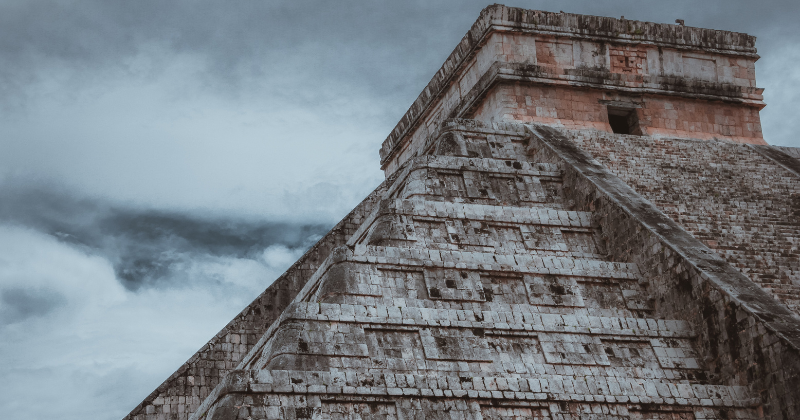 close up of the top of an aztec stone building