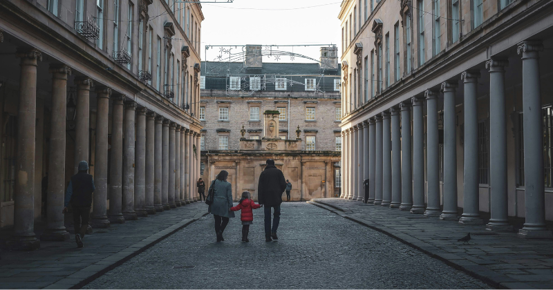 a family walking down a cobbled street