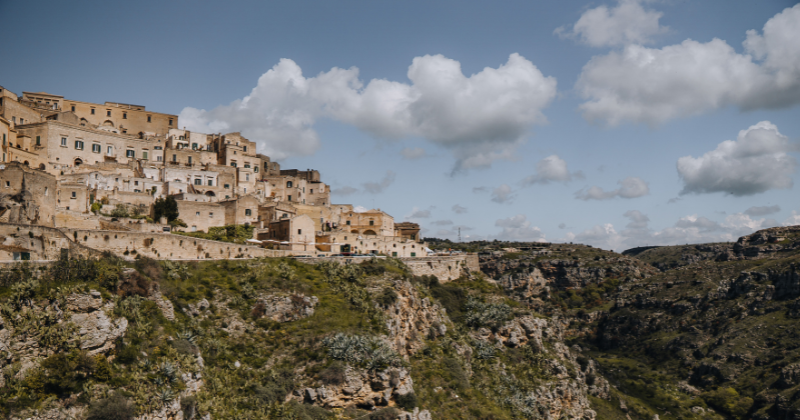 rocky cliff of matera with light stone houses built on top