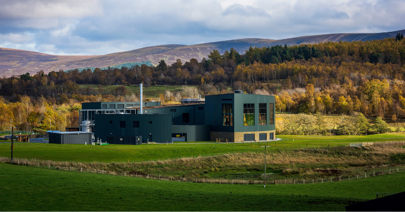 a metal building in a landscape