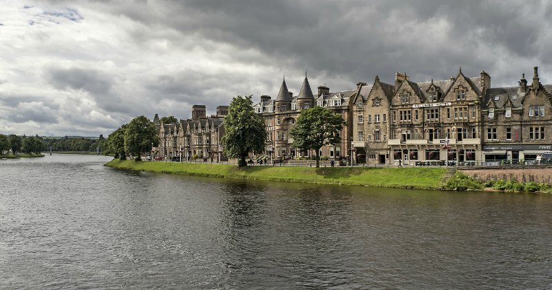 old buildings of a city beside a river