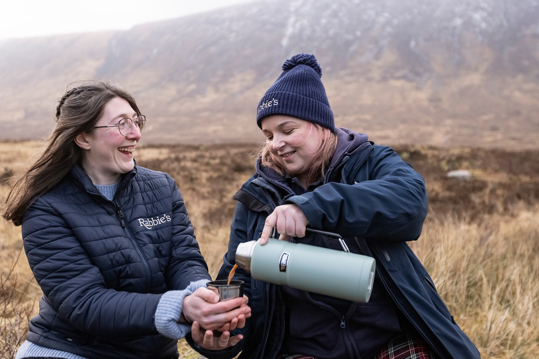 Smiling Rabbie's Driver Guides sharing a cup of tea