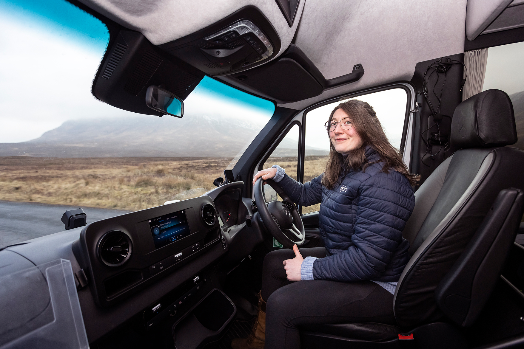 rabbie's driver guide sitting in the driving seat on a rabbie's bus
