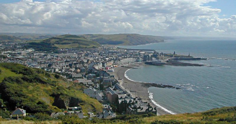 birds eye of a coastal town with a beach front and the sea