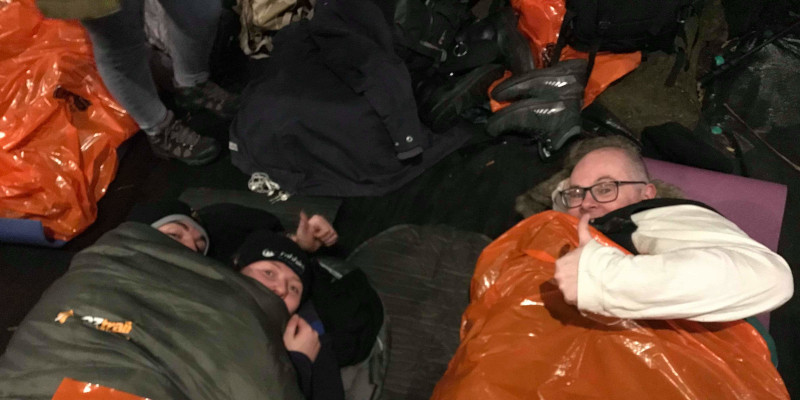 three people cosy in their sleeping bags