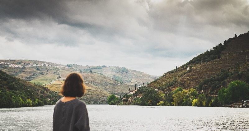 female looking out over a large lake
