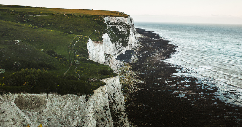 white cliffs of dover edge with green fields on top