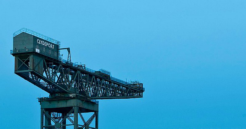 A large industrial crane at Clydeport against a blue sky, symbolizing the maritime heritage of the area.