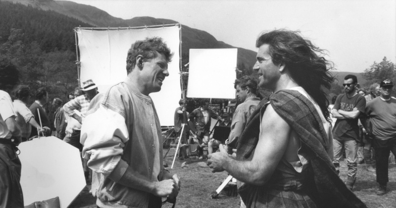 a black and white photo of men on a film set