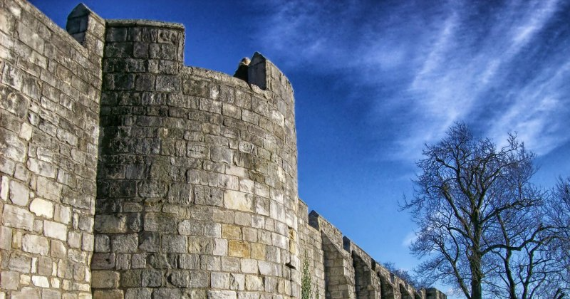 close up of a stoned wall with blue sky in the background