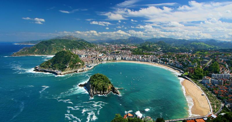 beach bay in san sebastian with bright blue waters and sky