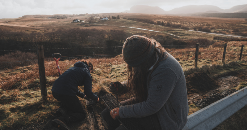 two people helping to prepare the new path to be laid