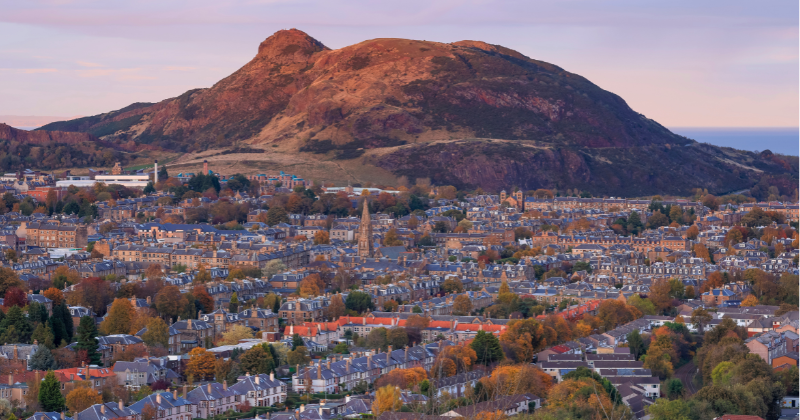a sprawling city under a large hill