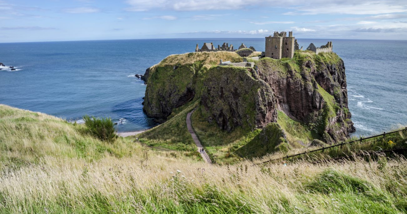 castle ruins on a rocky outcrop overlooking the ocean