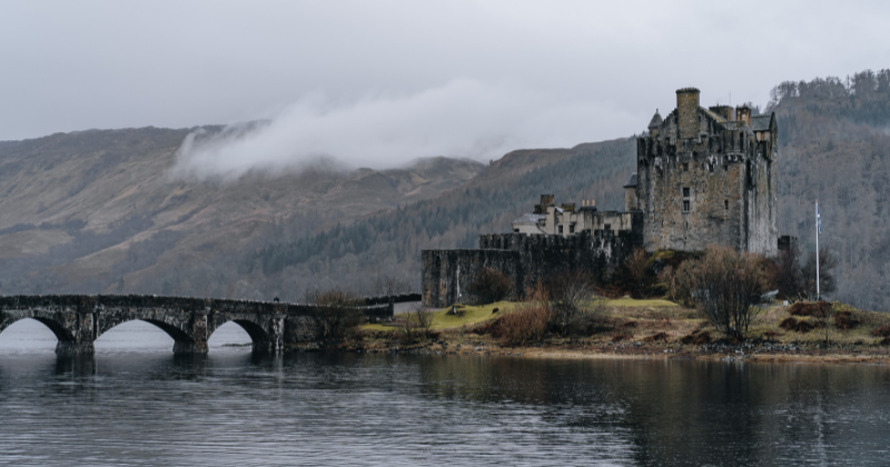 a bridge leading to a castle on a tidal island