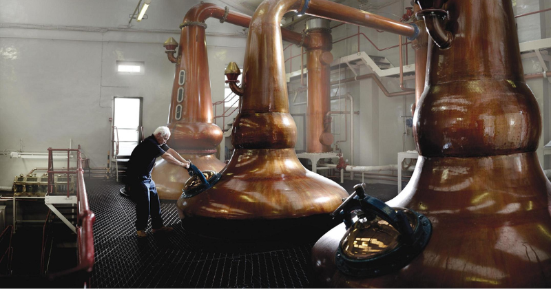 a man working on whisky stills