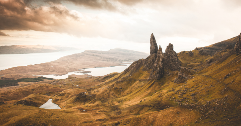 a sharp rock pinnacle overlooking a landscape