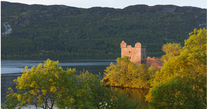 a ruined castle by a loch