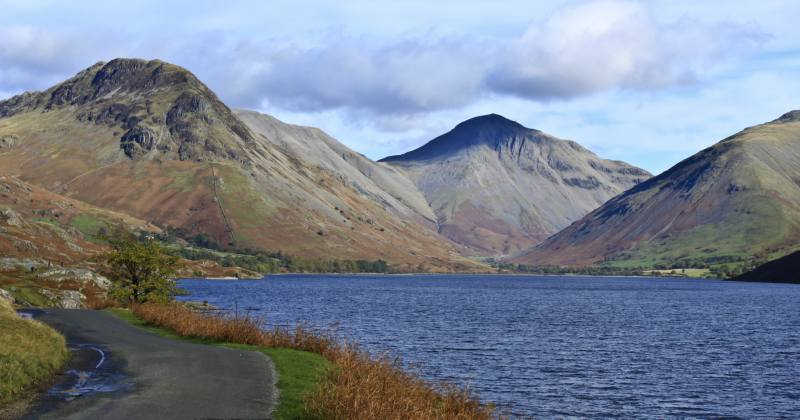 three mountains in the background with a blue lake in the middle
