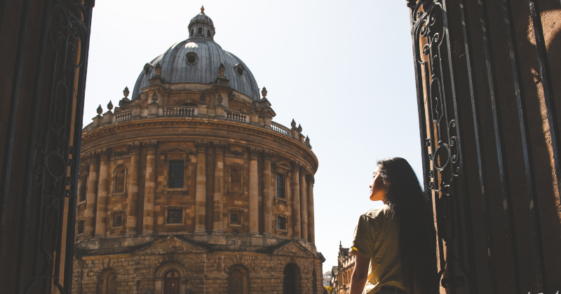 oxford domed building with a lady standing to the right hand side looking up